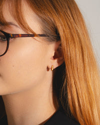 Huggie hoop earrings in 18ct gold vermeil on model