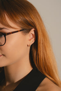 woman wearing Gold vermeil ear stack with lab grown diamonds.