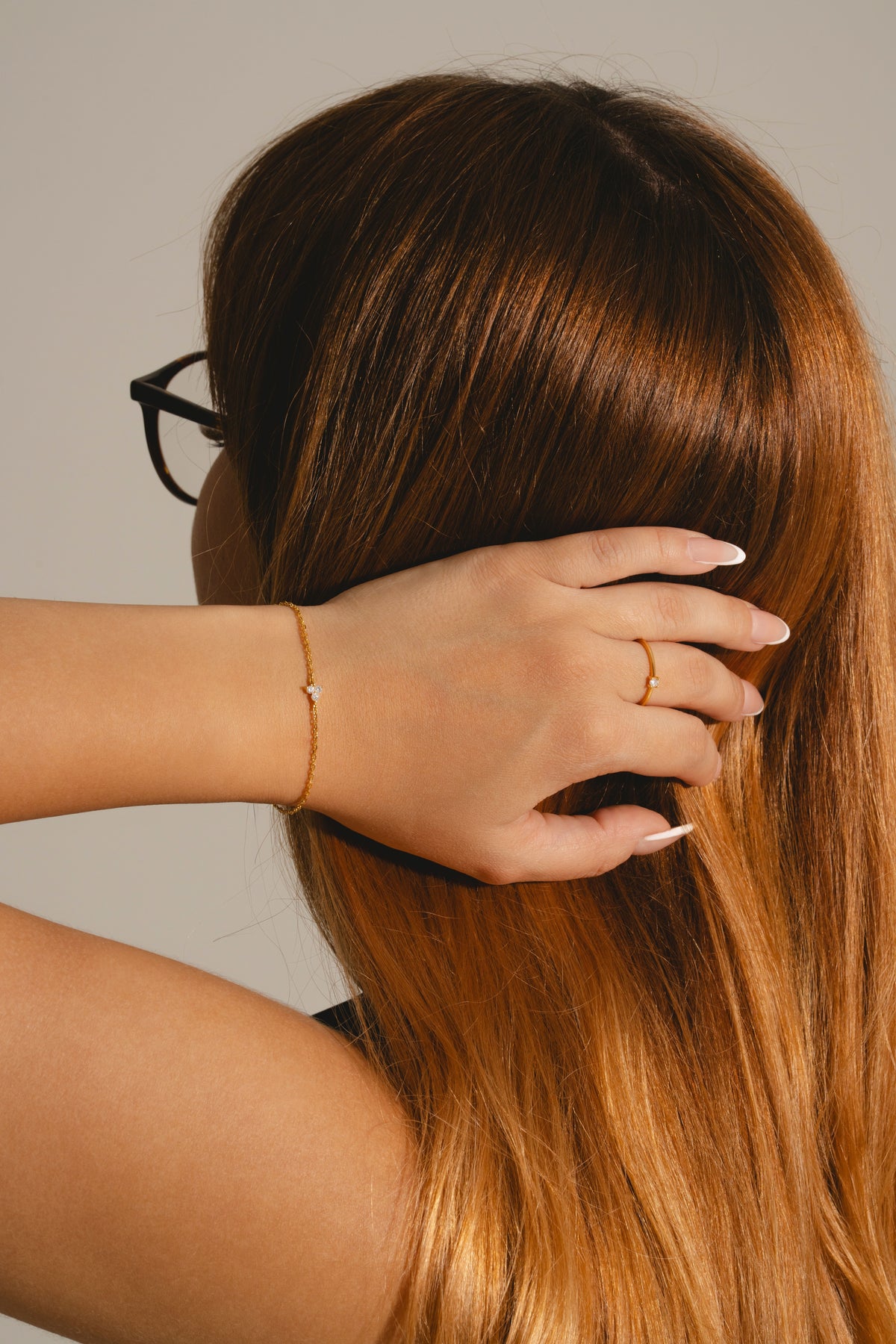 Trinity bracelet and solitaire ring in 18ct gold vermeil on model