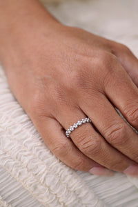 Close-up of a hand wearing a beaded ring in sterling silver