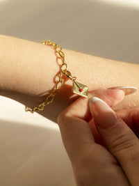 model wearing enamel letter charm with red heart