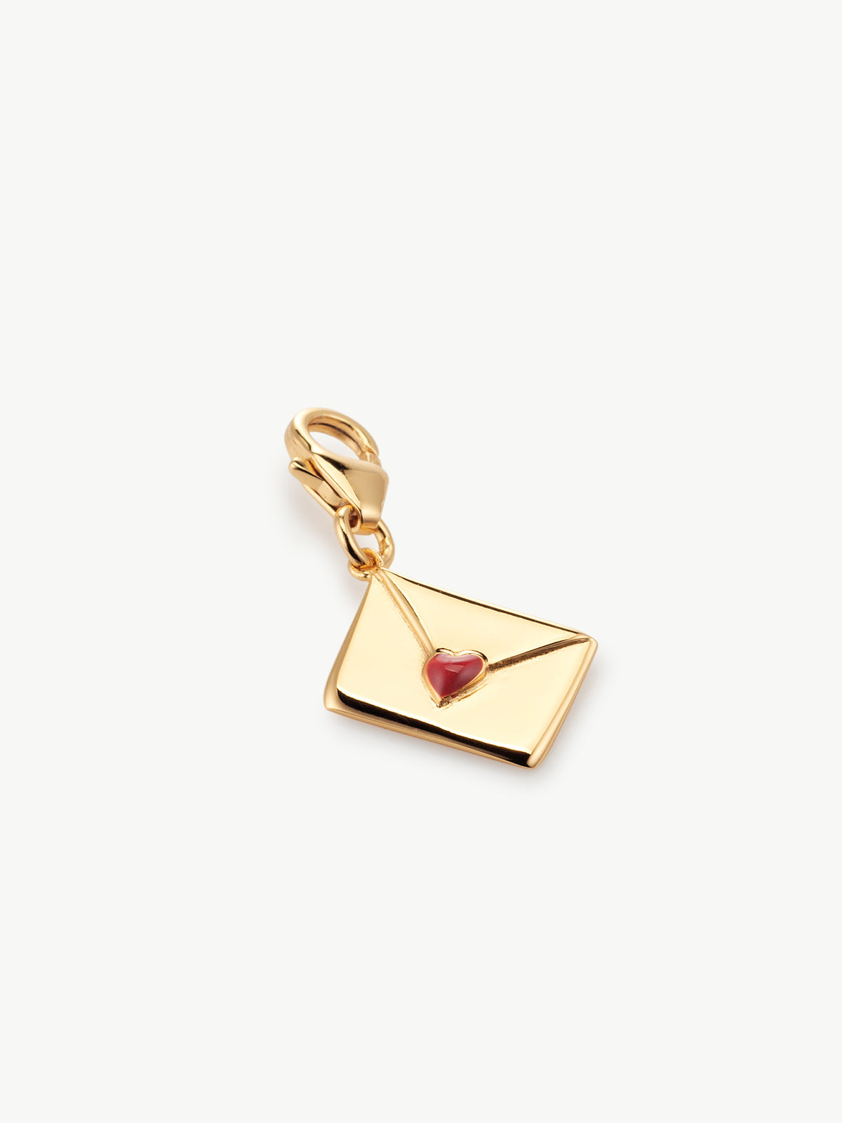 enamel letter charm with red heart in gold laying flat