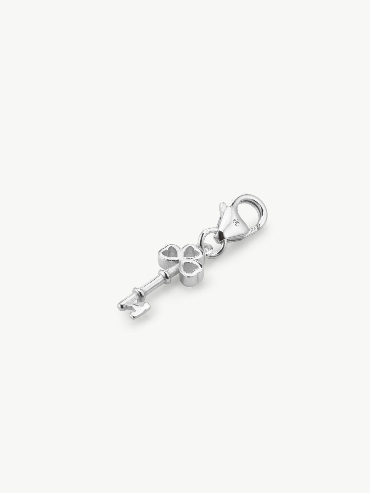 key charm in silver laying flat