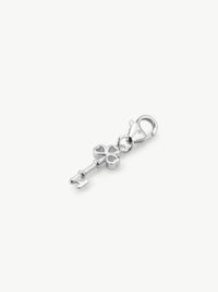 key charm in silver laying flat