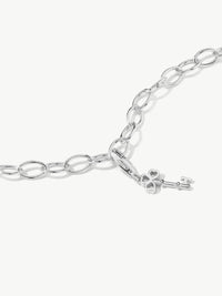 key charm on bracelet in silver laying flat