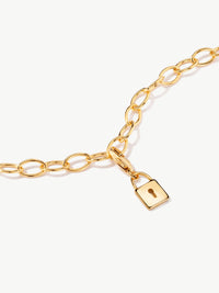 lock charm on bracelet in gold laying flat