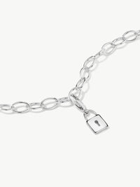 silver lock charm on bracelet